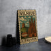 A metal stamp depicting a castle and hill in Vilnius, Lithuania, with the text "Vilnius" and "Lithuania" printed on it.