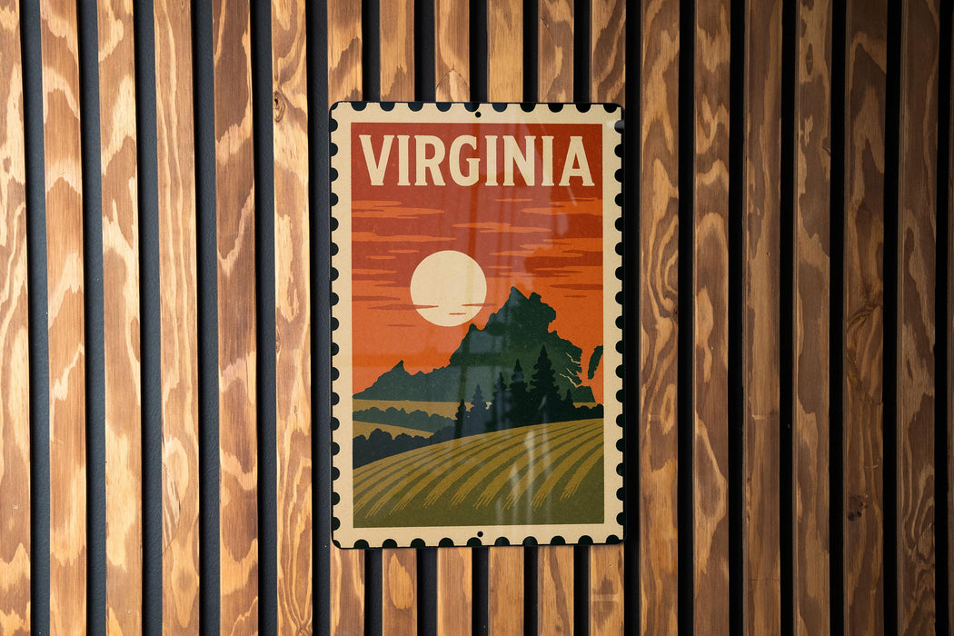 A vintage-style postage stamp depicting a scenic landscape with mountains, trees, and a sunset, hanging on a wooden wall.