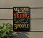 a sign with the text "All I care about is skiing...and maybe 3 people" displayed on a wall.