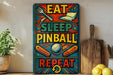 a colorful sign with the text "EAT SLEEP PINBALL REPEAT" in a vibrant, comic book-style design.