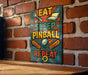 a colorful sign with the text "EAT SLEEP PINBALL REPEAT" displayed on a brick wall.