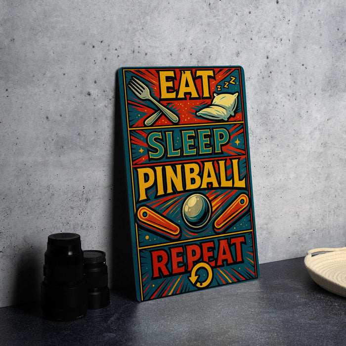 a colorful sign with the text "EAT SLEEP PINBALL REPEAT" in a vibrant, retro style.