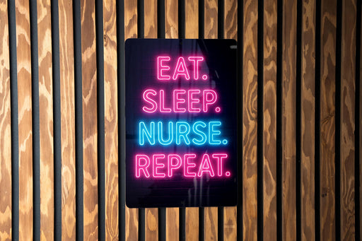 a sign with the text "EAT. SLEEP. NURSE. REPEAT." in neon colors, mounted on a wooden wall.