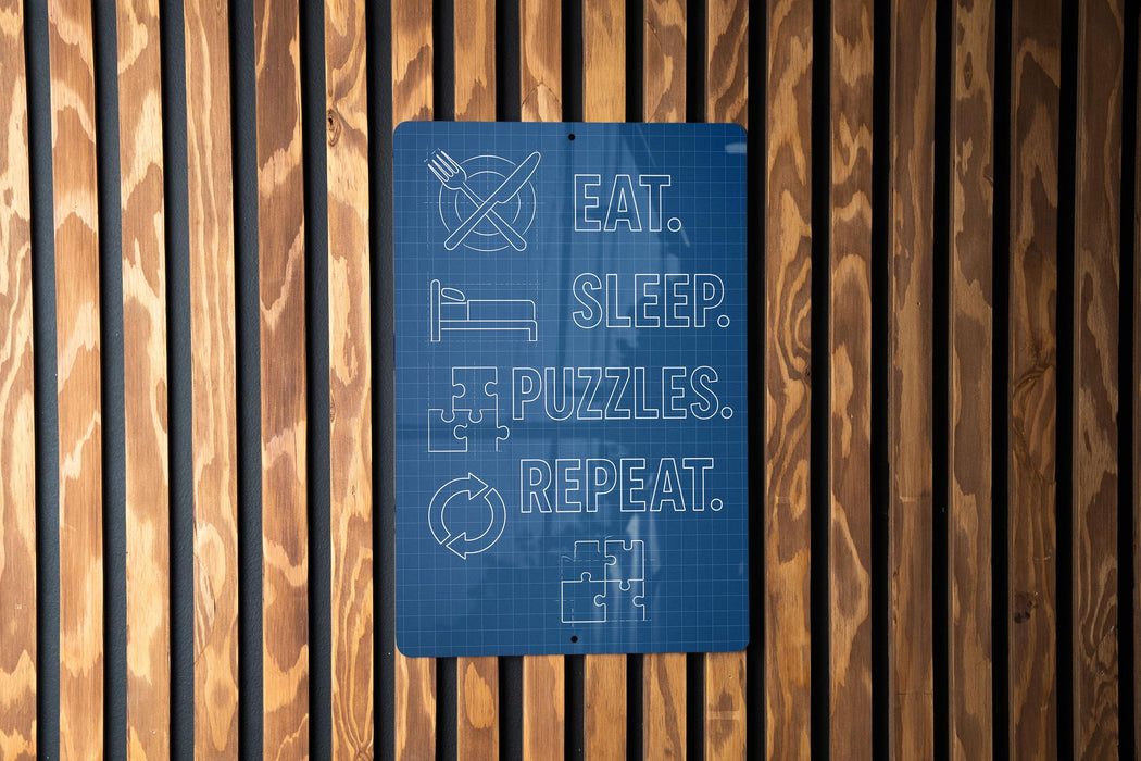 a blue sign with white text that reads "EAT. SLEEP. PUZZLES. REPEAT."