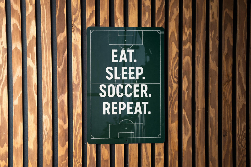 a sign with the text "EAT. SLEEP. SOCCER. REPEAT."