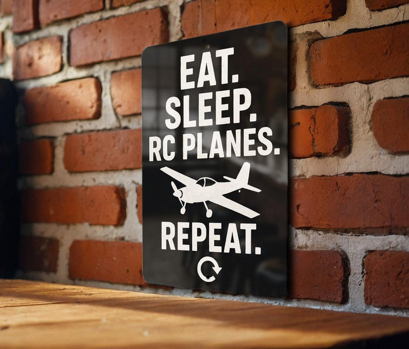 a sign with the text "EAT. SLEEP. RC PLANES. REPEAT." and a small airplane graphic.