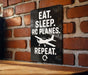 a sign with the text "EAT. SLEEP. RC PLANES. REPEAT." and a small airplane graphic.