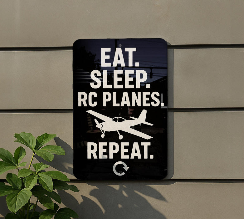a sign with the text "EAT. SLEEP. RC PLANES. REPEAT." and a small airplane graphic.