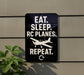 a sign with the text "EAT. SLEEP. RC PLANES. REPEAT." and a small airplane graphic.