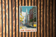 A framed vintage-style photograph of a street scene in San Francisco, with a trolley car visible in the background.