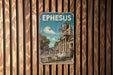 A vintage metal sign with the word "EPHESUS" on it, featuring an illustration of an ancient Greek temple or ruins.