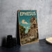 A vintage-style metal sign with the word "EPHESUS" prominently displayed, featuring an illustration of an ancient Greek temple or ruins against a blue sky with a full moon.