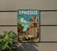 A vintage-style metal sign with the word "EPHESUS" displayed prominently, featuring an image of an ancient Greek temple or ruins.