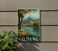 A vintage-style poster of Salzburg, Austria, featuring a scenic landscape with a mountain, church, and river, is displayed on a wall.