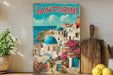 A vintage-style poster of Santorini, Greece, featuring colorful buildings, blue domes, and a scenic view of the Mediterranean Sea.