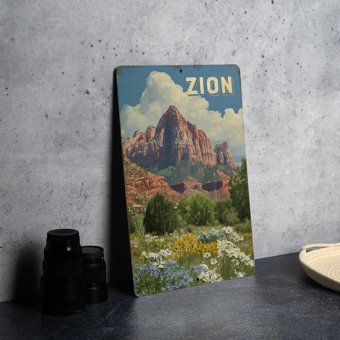 A vintage-style metal sign with a landscape of mountains and a field of flowers, with the word "ZION" prominently displayed.