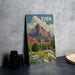 A vintage-style metal sign with a landscape of mountains and a field of flowers, with the word "ZION" prominently displayed.