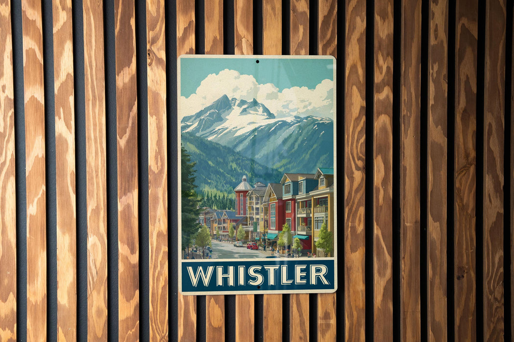 A vintage-style poster of Whistler, a mountain town in British Columbia, Canada, is displayed on a wooden wall.