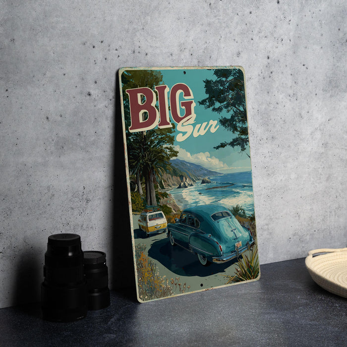 A vintage-style metal sign with a scenic coastal landscape featuring a car and palm trees, with the text "BIG Sur" prominently displayed.