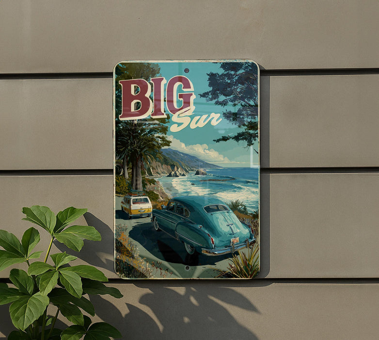 A vintage-style sign with the text "BIG SUR" displayed prominently, featuring a scenic coastal landscape with a car driving along a road.