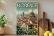 A framed vintage poster of Florence, Italy, featuring the iconic dome of the Cathedral of Santa Maria della Salute, surrounded by a picturesque cityscape.