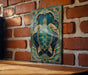 A decorative metal panel featuring a detailed illustration of a turtle against a blue background with gold accents.