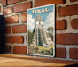 A vintage-style poster of the Mayan pyramid of Tikal, a famous landmark in Guatemala, is displayed on a brick wall.