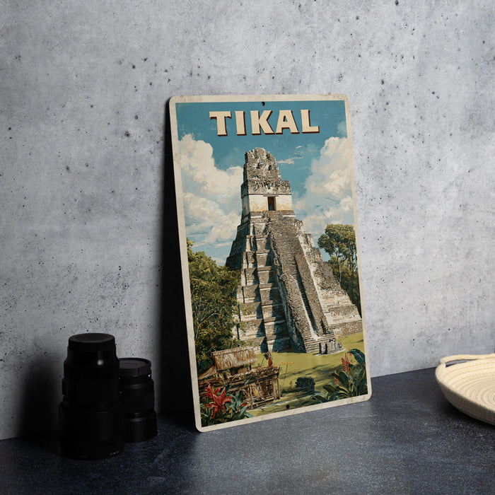 A vintage-style metal sign displaying the image of the Mayan pyramid of Tikal, a famous landmark in Guatemala.