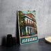A vintage metal sign featuring an image of a colorful building in Havana, Cuba, with a classic car parked in front.