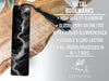 a metal bookmark with a black and white lightning bolt design, placed on a wooden surface.