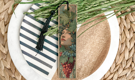 a decorative bookmark with a floral design, placed on a plate with a striped pattern.
