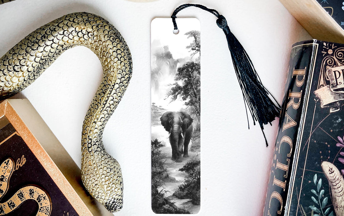 a black and white photograph of an elephant walking through a forest, with a decorative snake and a book titled "Practice" on display.