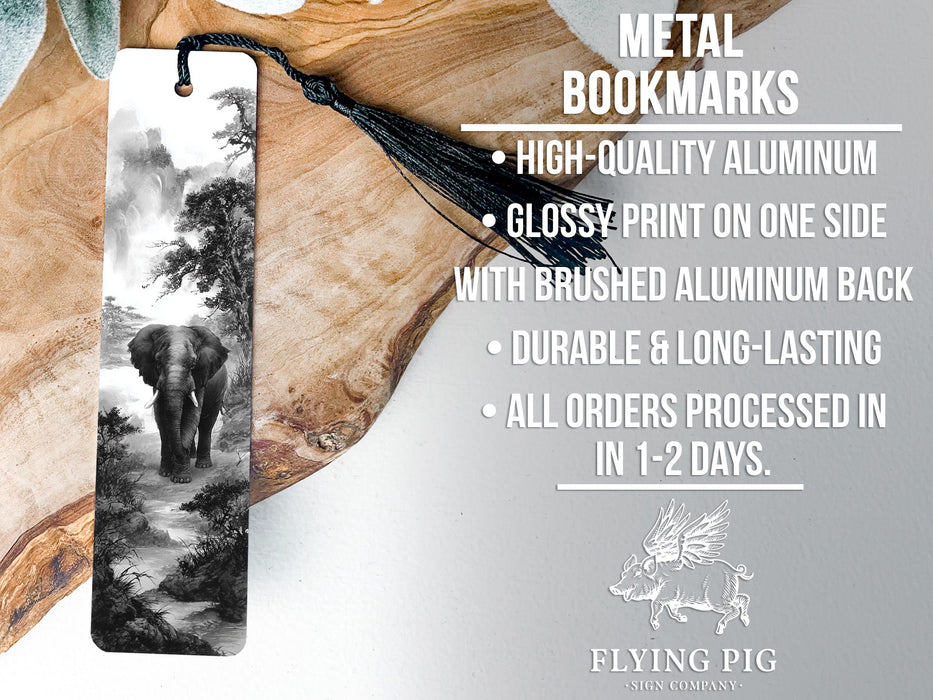 a metal bookmark with a black and white elephant image on it, placed on a wooden surface.