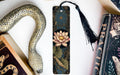 a decorative snake-shaped bookmark with a floral design, placed next to a book titled "Practice".