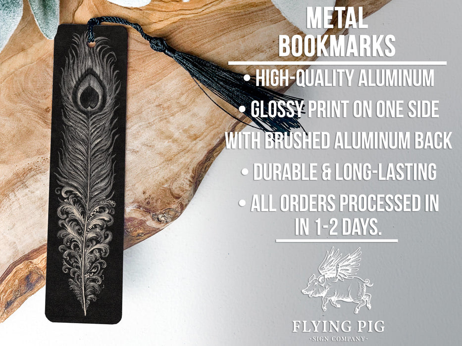 a metal bookmark with a feather design, placed on a wooden surface.