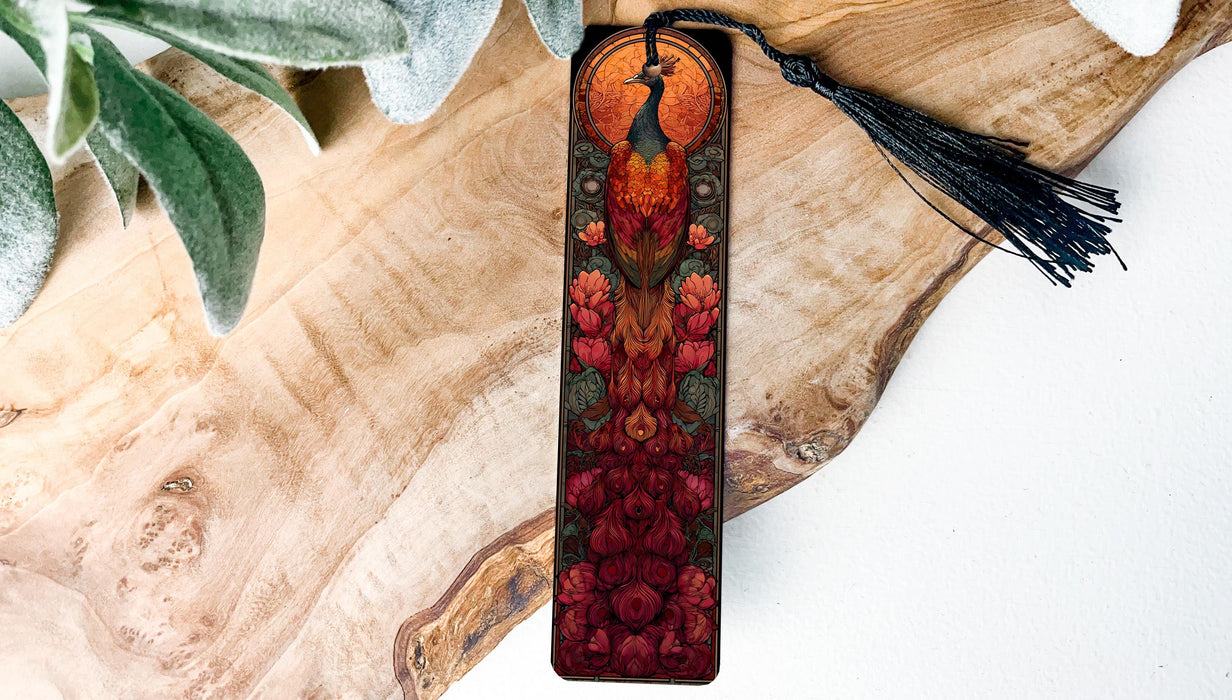 A decorative bookmark with a peacock design, featuring a vibrant red and orange color scheme with intricate floral patterns.