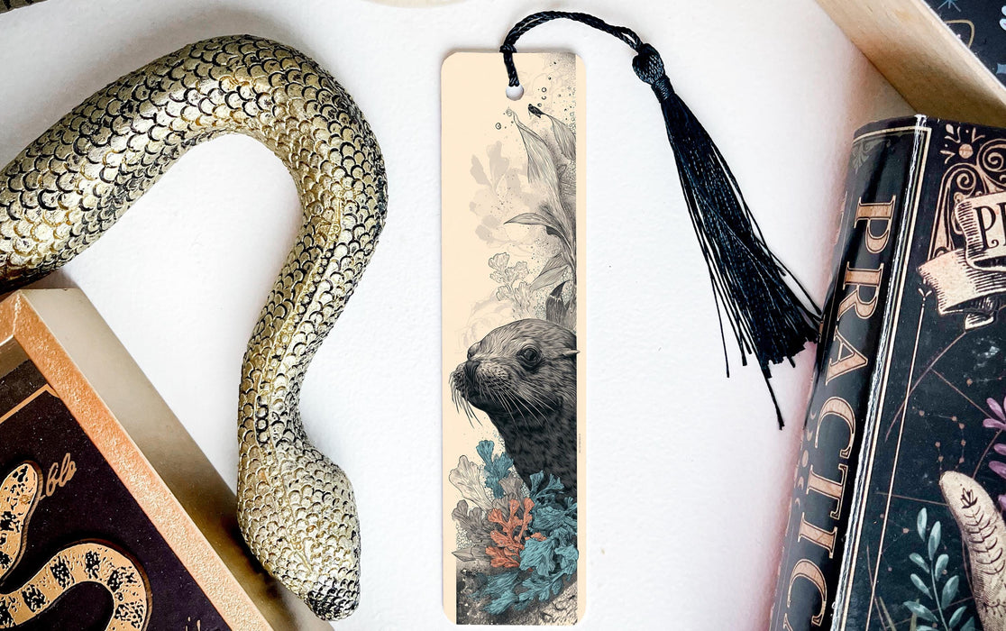 a decorative snake-shaped bookmark with a floral design, placed next to a book titled "Practice" and a black tassel.