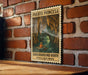 A vintage-style poster of a cave with a person in a boat, mounted on a brick wall.