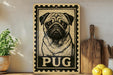 A vintage-style pug dog sign with the word "PUG" printed on it, displayed on a shelf next to a wooden cutting board and some kitchen utensils.