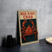 A framed poster of a red king crab is displayed on a wall, with a stack of black cups and a white dish visible to the side.