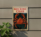 A sign for "Red King Crab" is displayed on a wall, featuring an illustration of a large red crab.