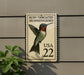 A postage stamp featuring a hummingbird, with the text "Ruby-Throated Hummingbird" and "USA 22" printed on it.