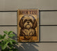 a sign with a dog illustration on it, mounted on a wall.