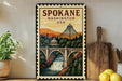 A framed vintage-style poster of the Spokane, Washington, USA bridge, featuring a scenic illustration of the bridge and surrounding landscape.