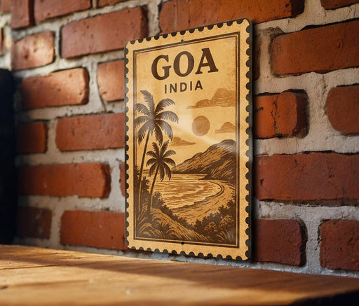 a vintage-style stamp or sign with the text "GOA INDIA" and a tropical landscape depicting palm trees, mountains, and a beach.