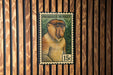 A postage stamp featuring a portrait of a proboscis monkey, which is a type of primate native to Southeast Asia.