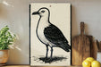 a black and white illustration of a seagull standing on a wooden surface, with a potted plant to the left and a wooden cutting board to the right.