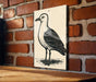 a black and white illustration of a seagull standing on a brick wall.