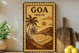 a vintage-style travel poster of Goa, India, with palm trees and a beach scene, displayed on a wall next to a wooden cutting board and some lemons.