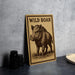 a wooden sign with a picture of a wild boar, placed on a table next to some black camera lenses.